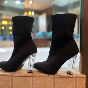 Black Shirt above ankle boots. Knit material .